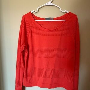 Athleta coral long sleeved athletic net-like shirt.